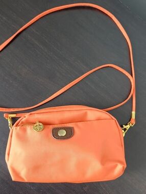 Compact Orange Crossbody Bag with Gold Accents